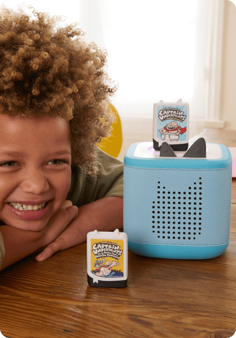 Child listening to audiobooks with a blue Toniebox 2