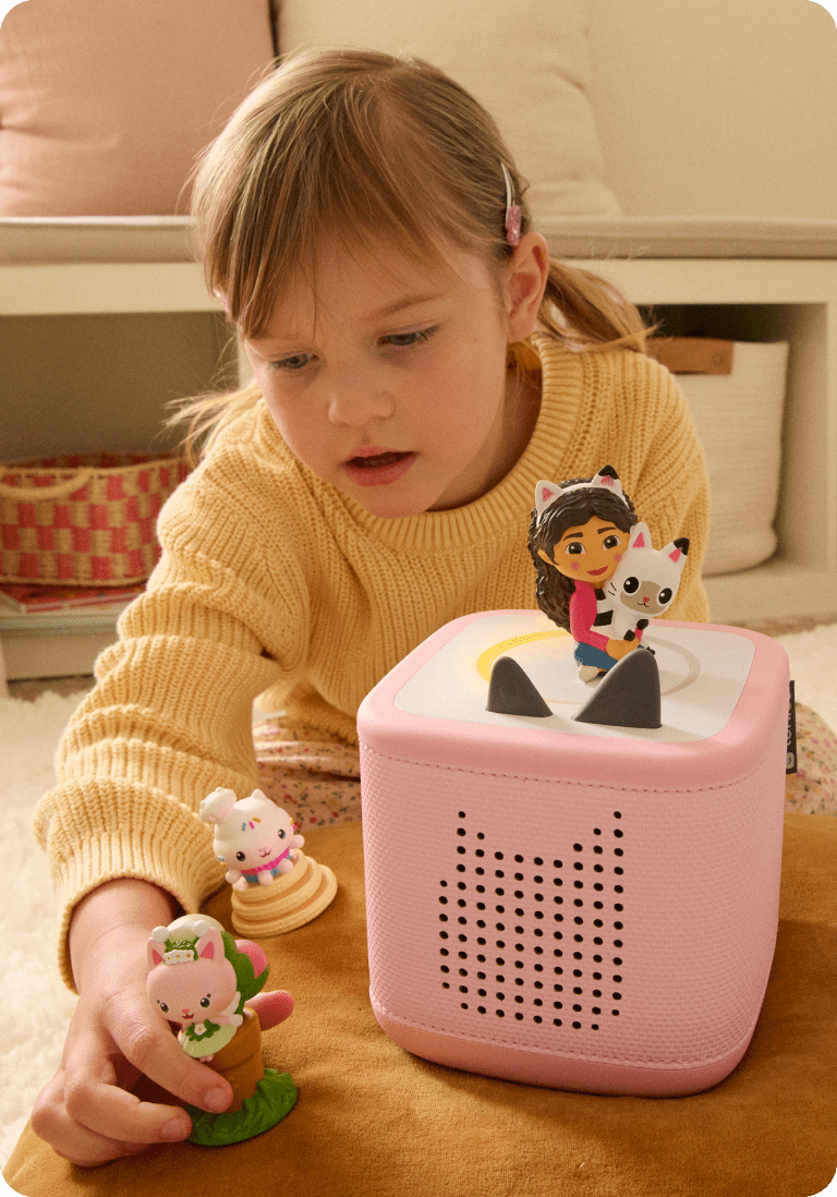 child playing with Gabby Dollhouse Tonies and pink Toniebox 2