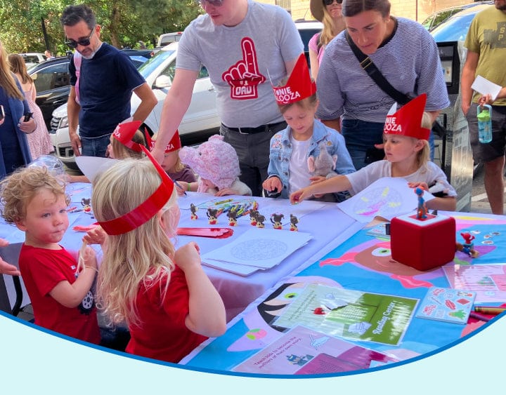 children outside doing crafts together while listening to a Toniebox
