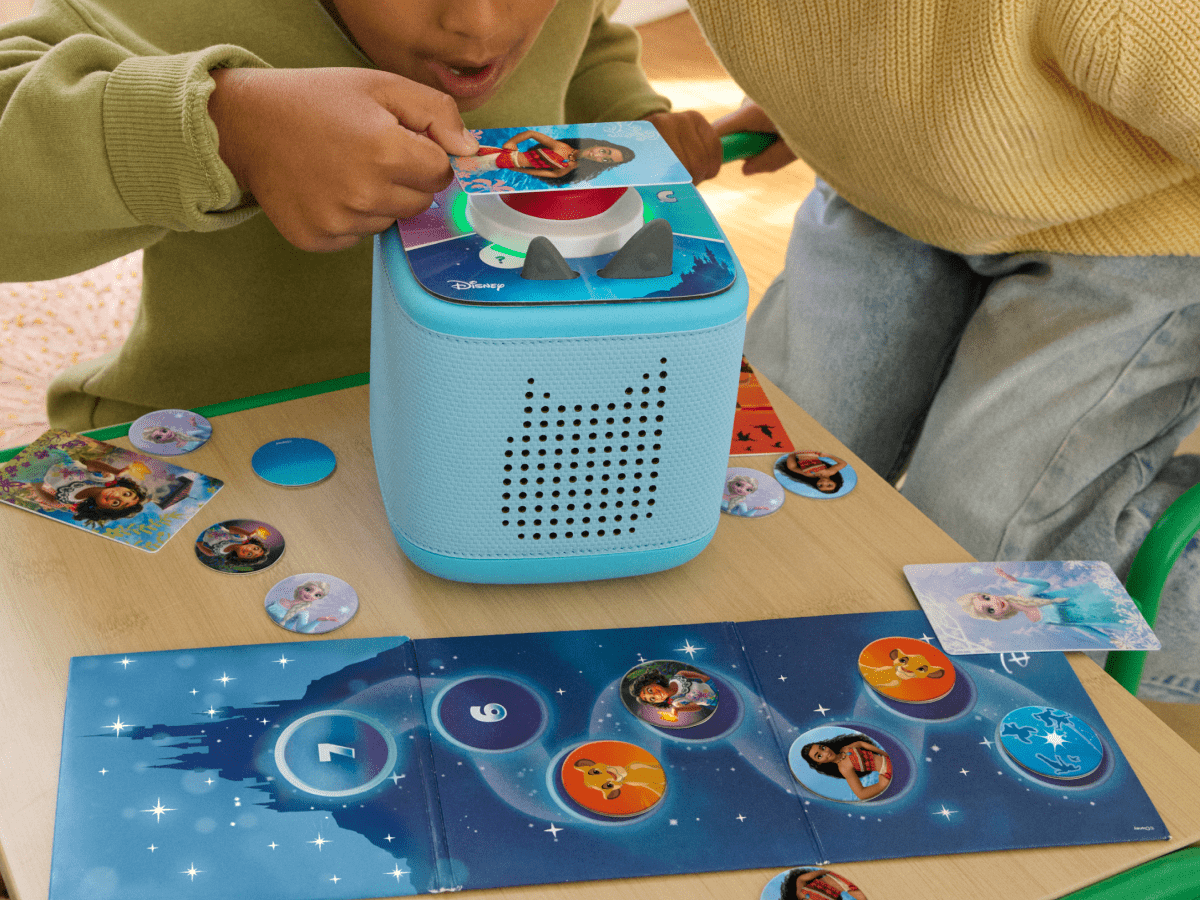 child playing with blue Toniebox 2, tonieplay controller and disney tonieplay game