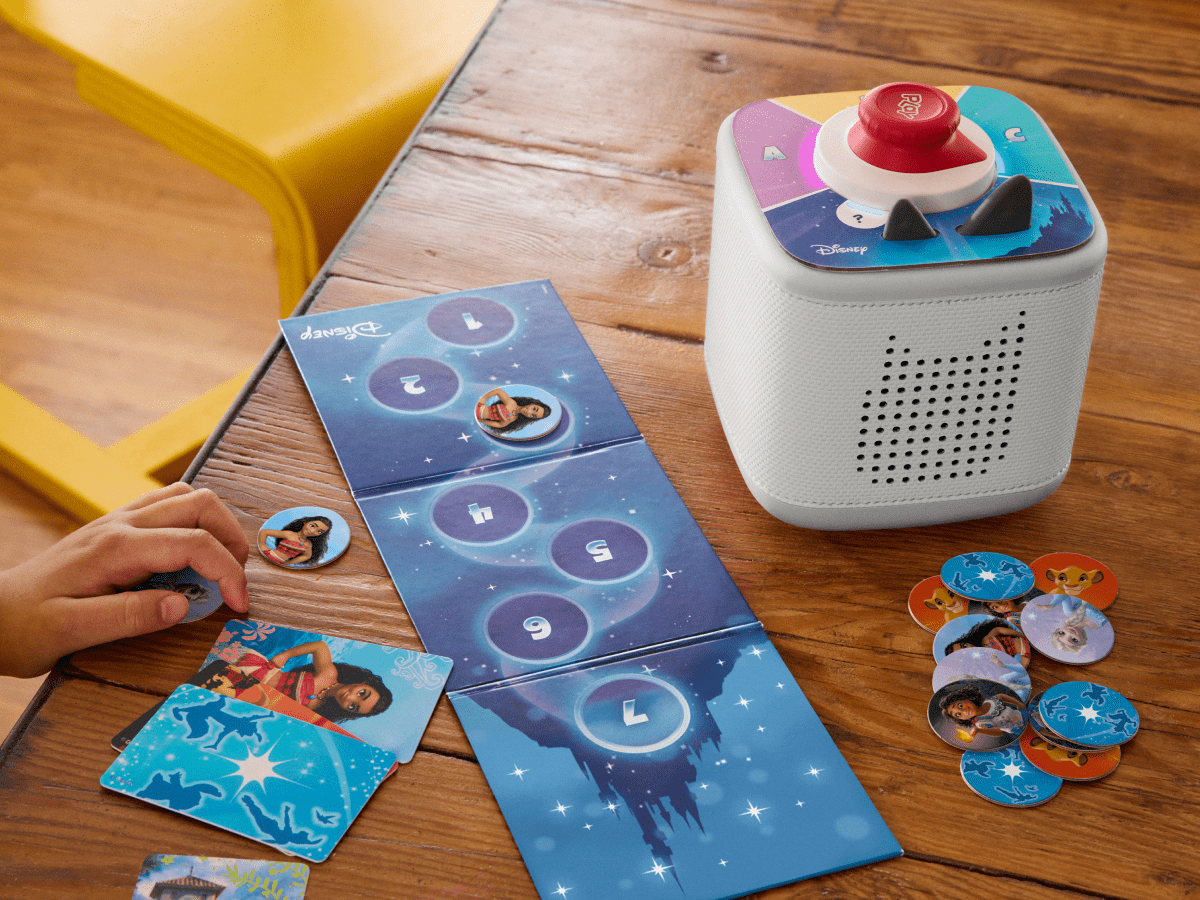 child playing with Toniebox 2, tonieplay controller, and disney tonieplay game
