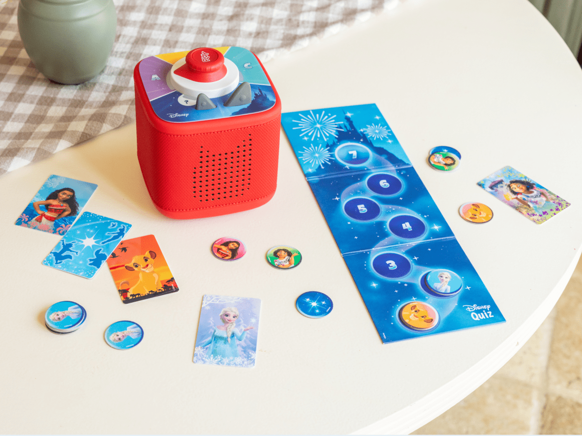 child playing with red Toniebox 2, tonieplay controller and disney tonieplay game