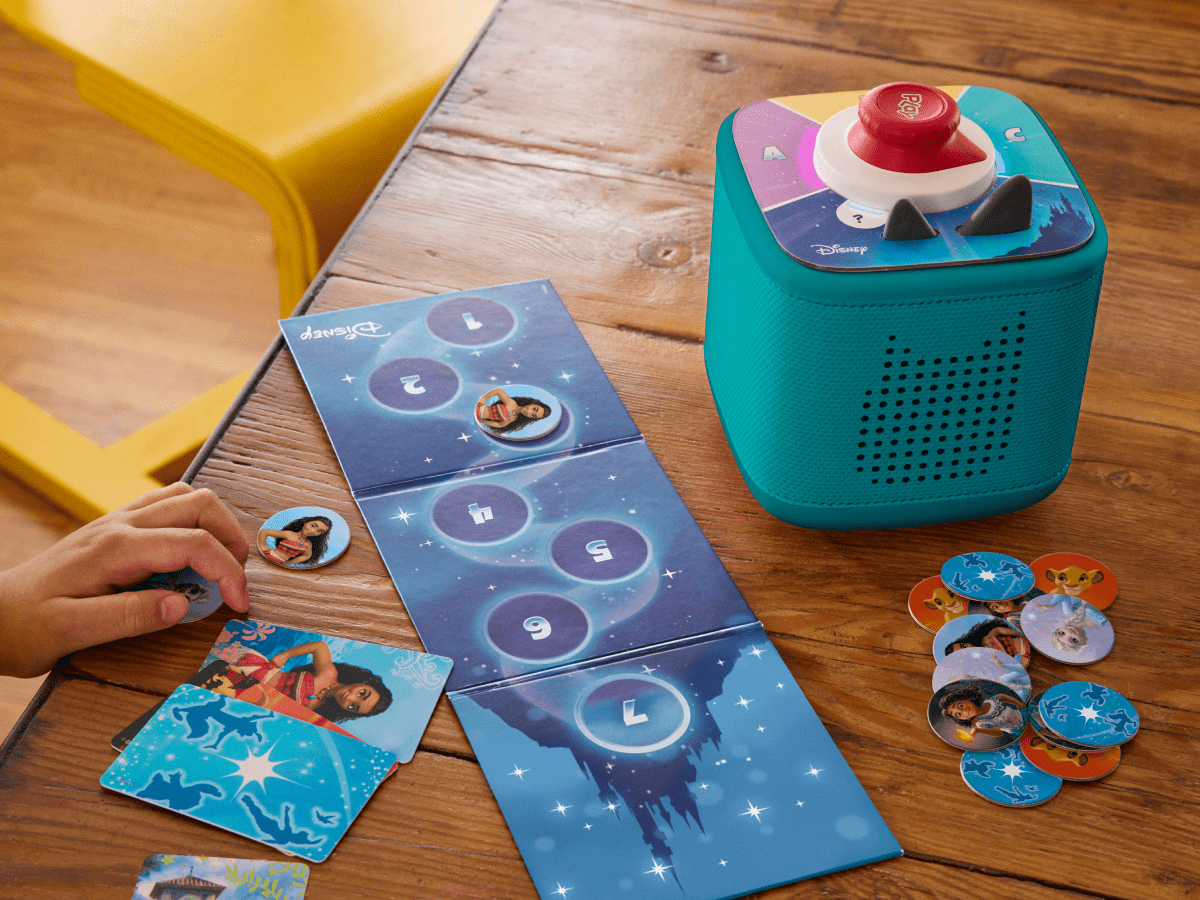 child playing with Toniebox 2, tonieplay controller, and disney tonieplay game