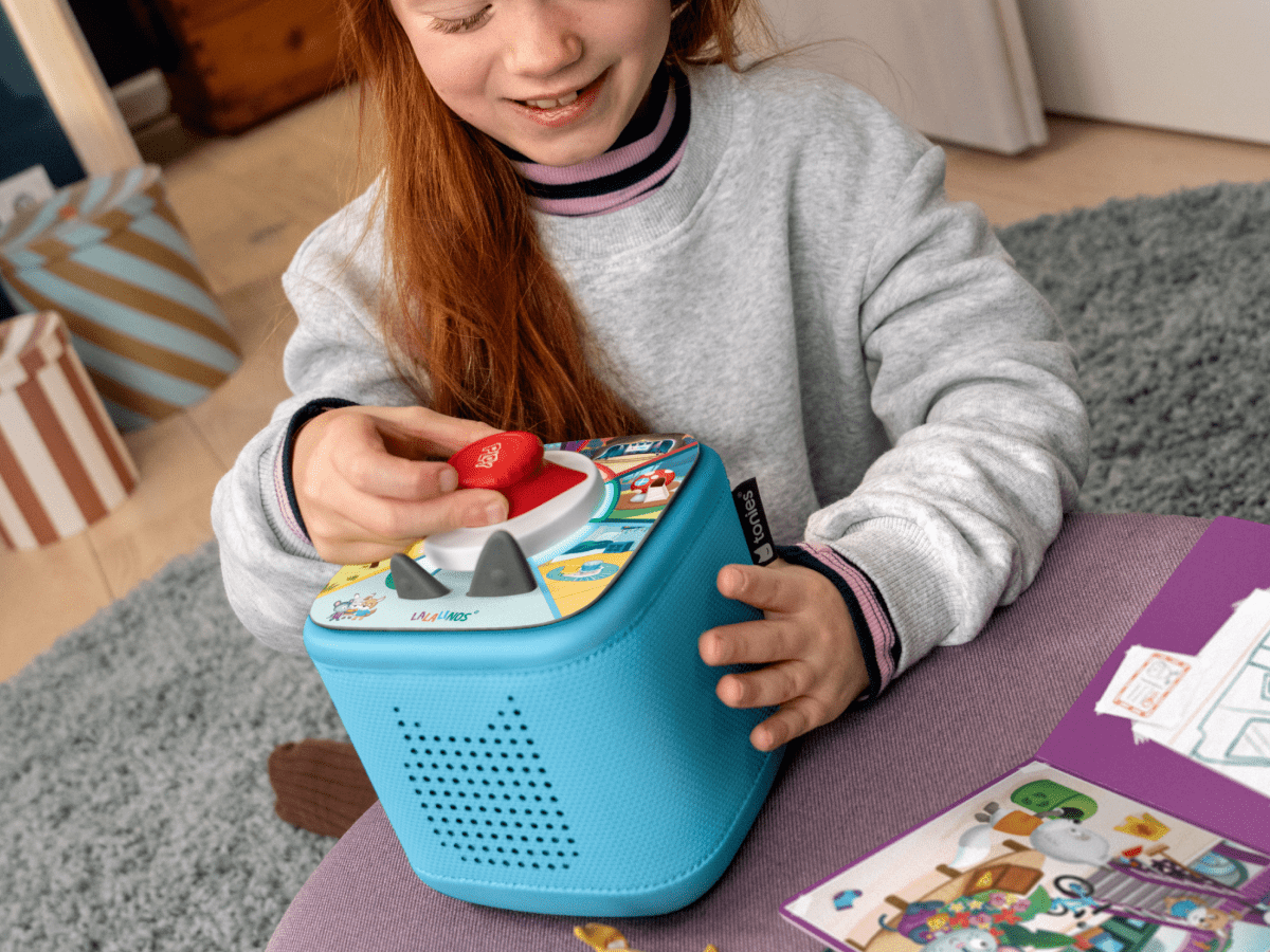 child playing with Lalalinos: Find the Photo - ToniePlay Game and a blue toniebox 2