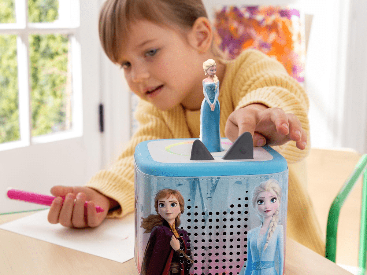 Child playing with a blue Toniebox 2 with a Disney Frozen Sleeve on it