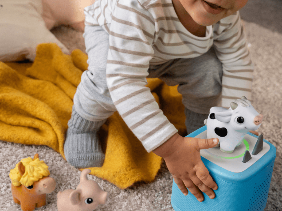 child playing with toniebox 2 and my first tonies horse, cow and pig