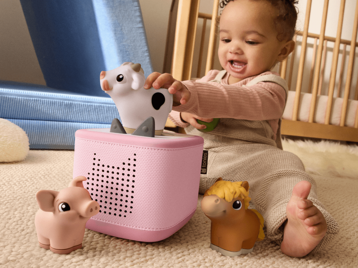 child playing with toniebox 2 and my first tonies horse, cow and pig