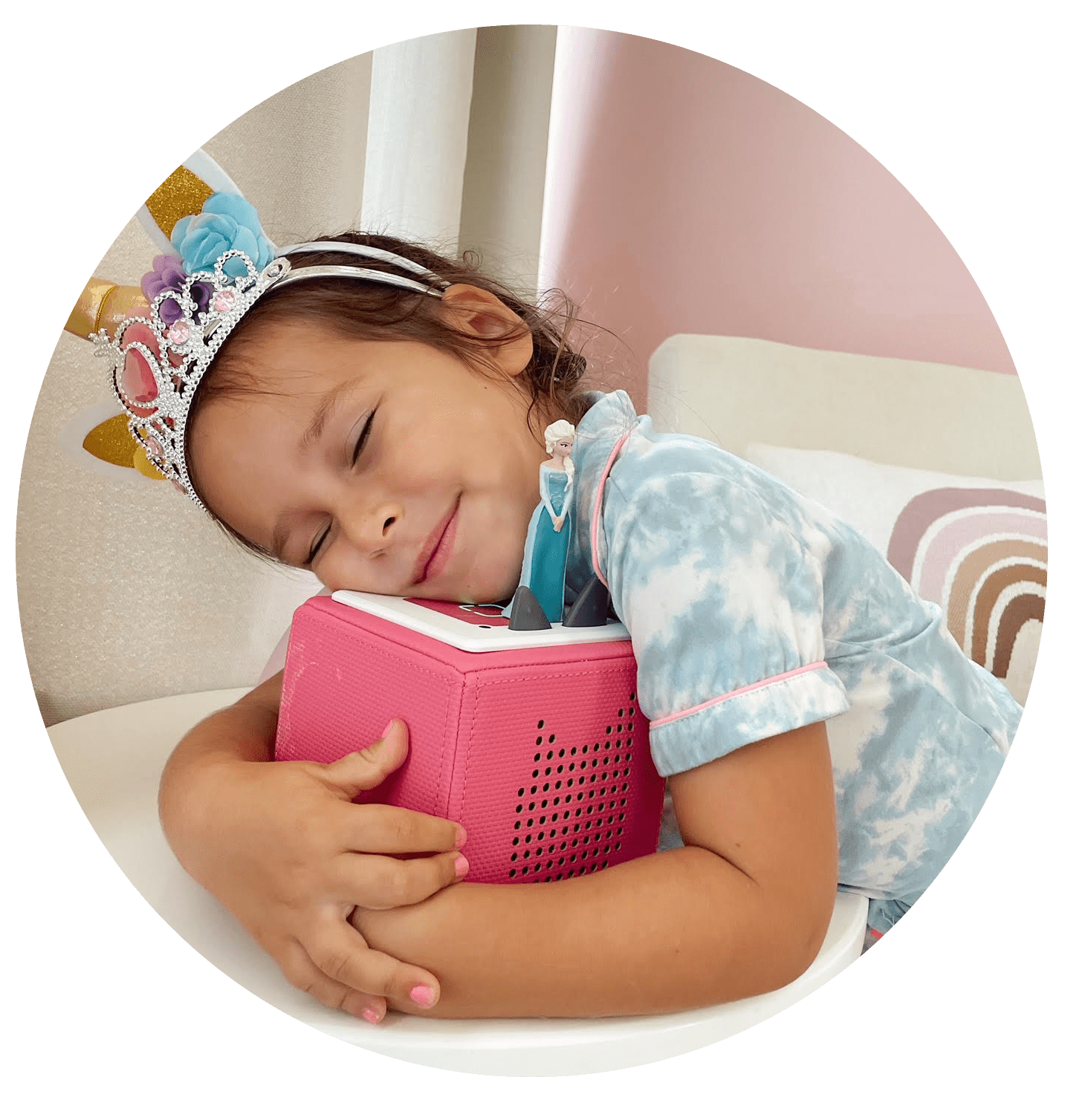 Young child hugging pink Toniebox with Frozen Tonie
