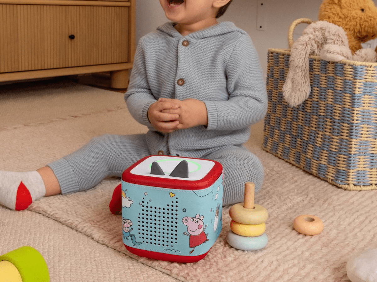 Child playing with Peppa Pig Sleeve on a red Toniebox 2