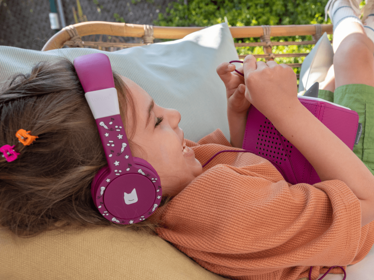 Child Using The Toniesâ® Purple Wired Headphones For Kids