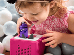 Child playing with Ask the StoryBots: Bo Tonie audio figurine and Toniebox 2