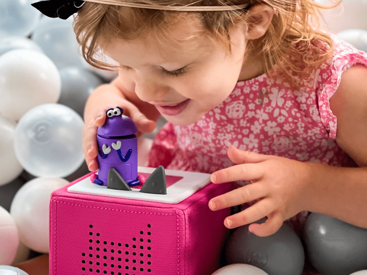 Child playing with Ask the StoryBots: Bo Tonie audio figurine and Toniebox 2