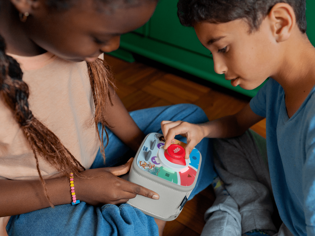 Kids playing with a red toniebox 2 and time academy toniplay