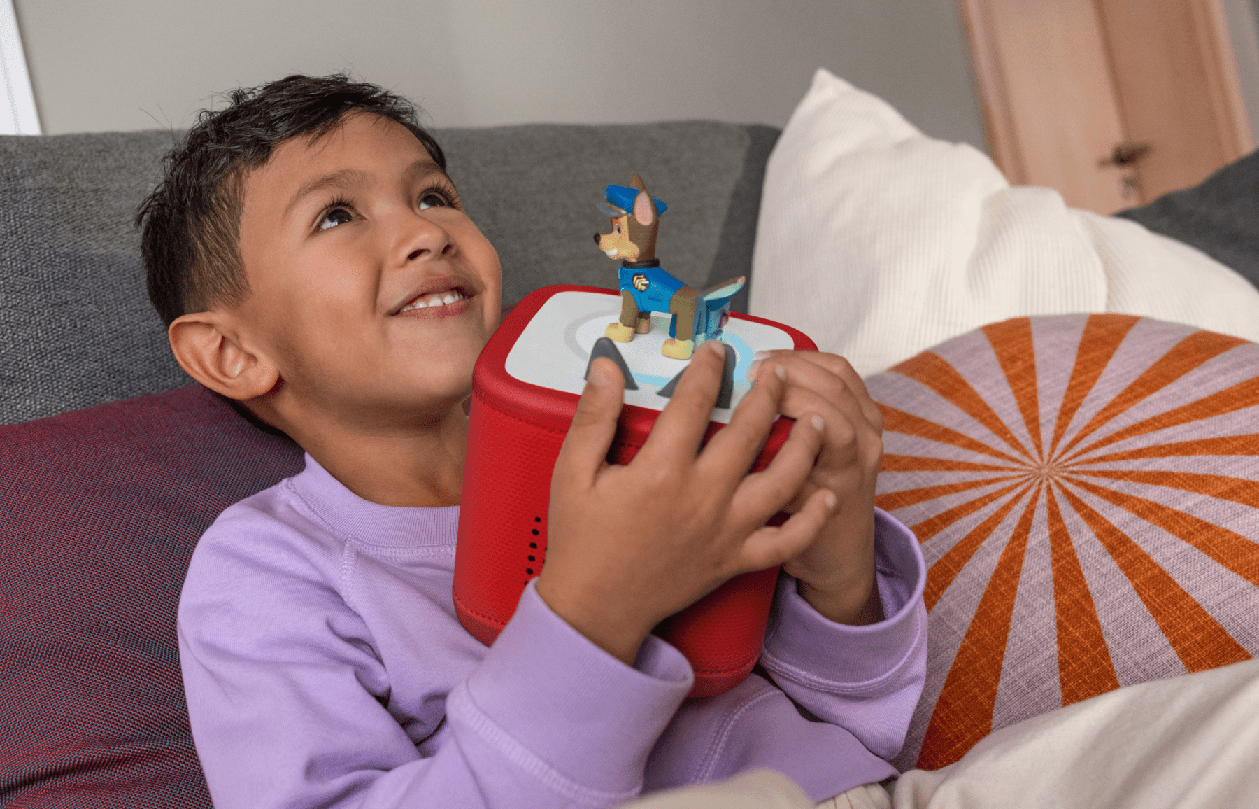 child listening to Chase Tonie on a red Toniebox 2