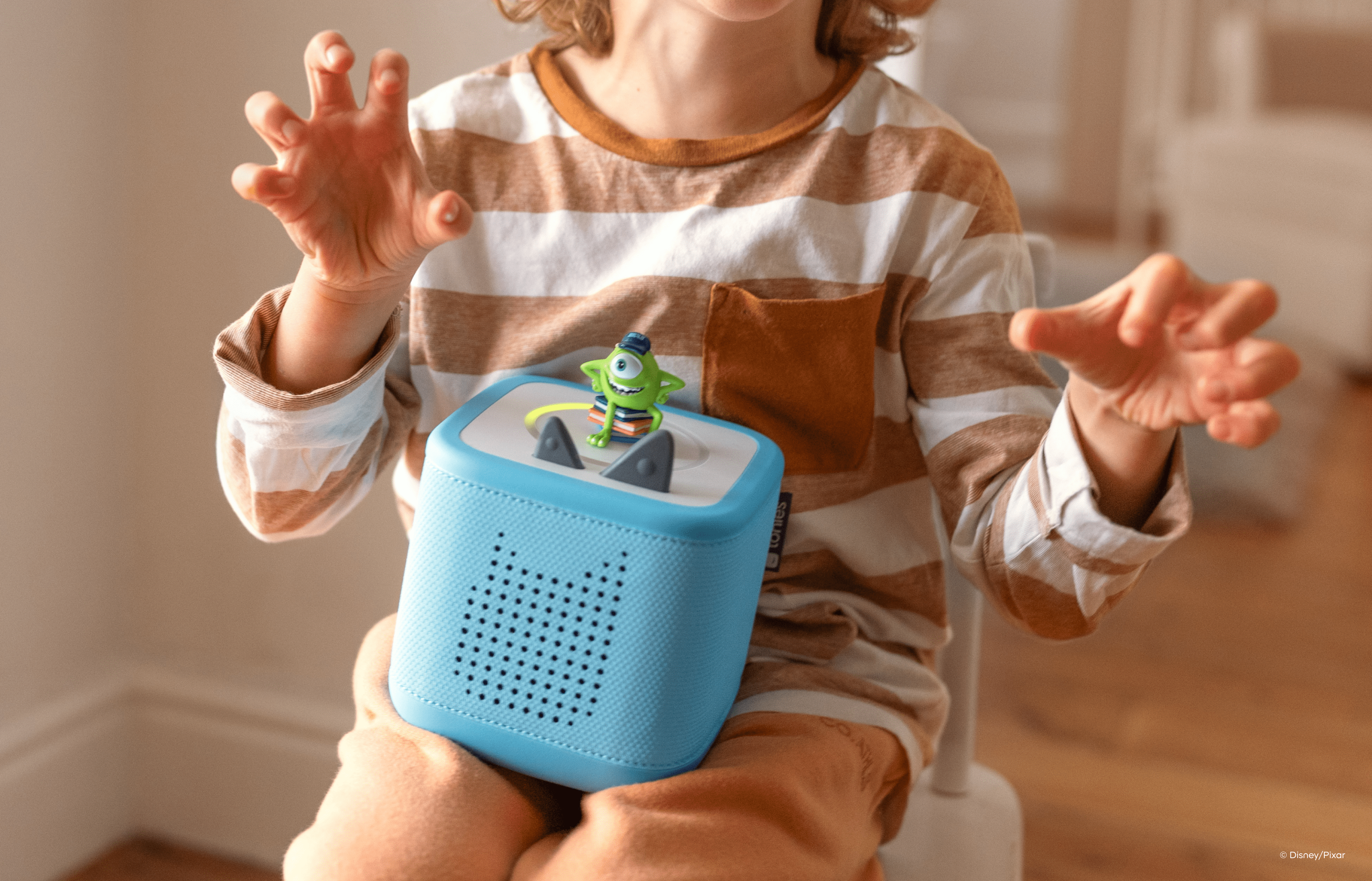child listening to Monsters University Tonie on blue Toniebox 2
