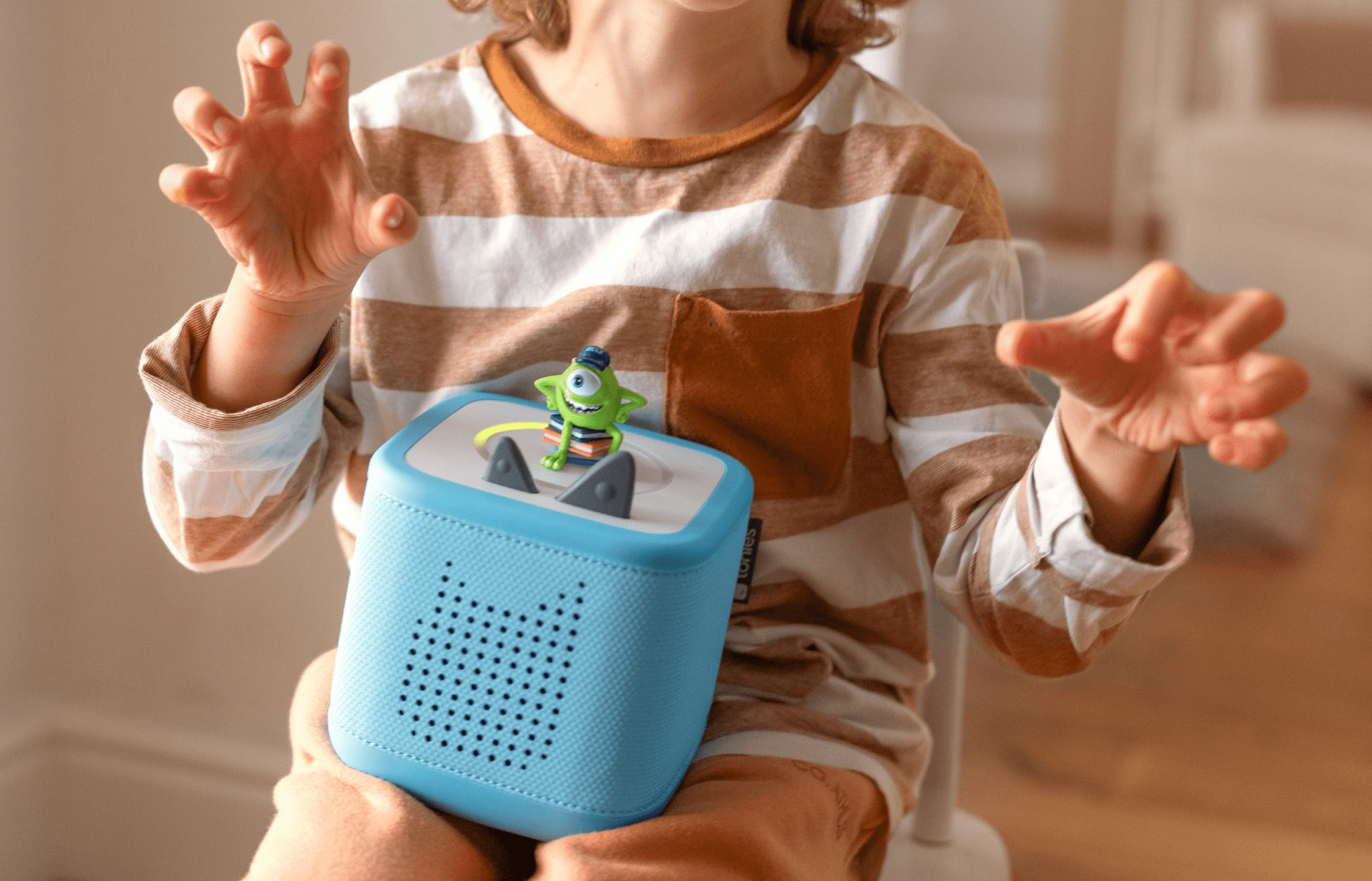 child listening to Monsters University Tonie on blue Toniebox 2