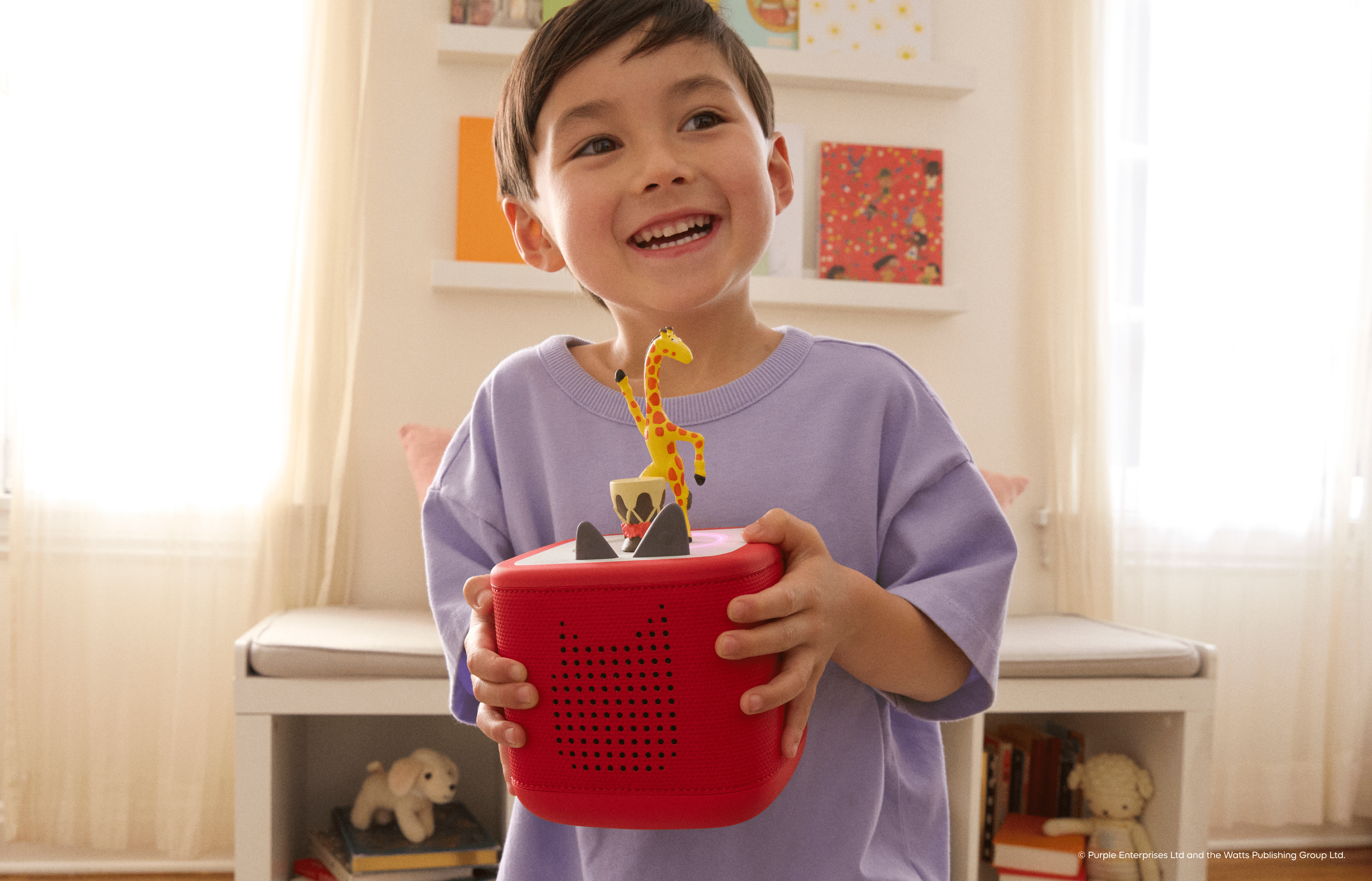 child listening to Giraffes Can't Dance Tonie on a red Toniebox 2