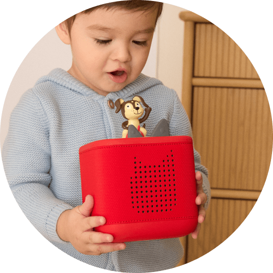 boy listening to playtime puppy tonie on a red toniebox 2