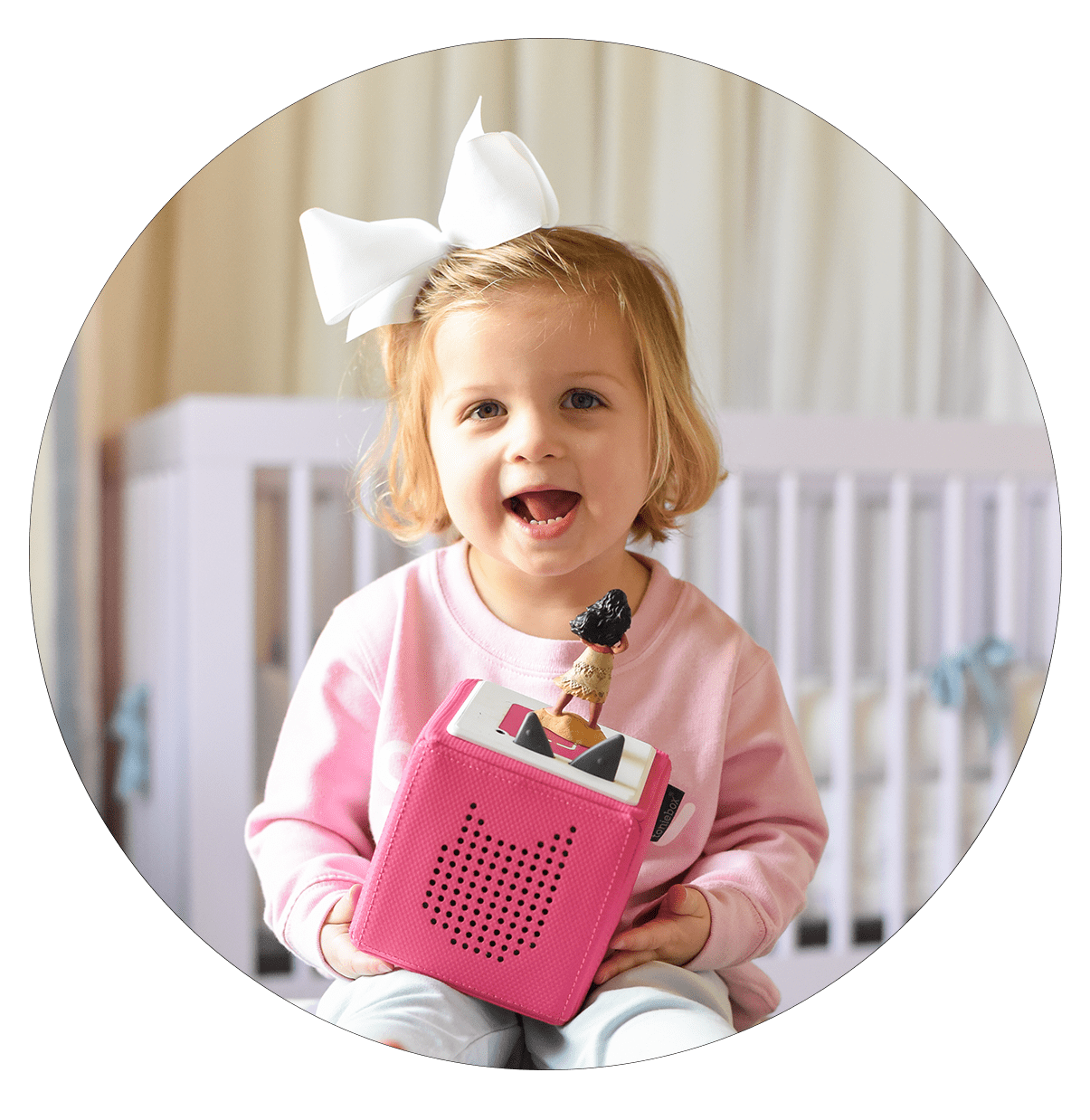 Young child with pink Toniebox and Moana Tonie