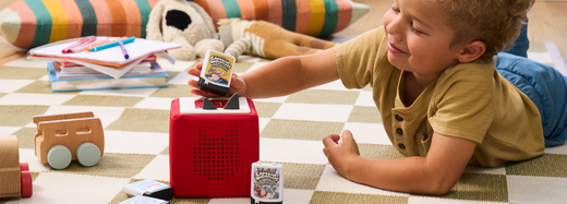 Child listening to audiobooks for kids with his Toniebox