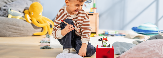 Child listening to a Creative-Tonie on his Toniebox for creative learning