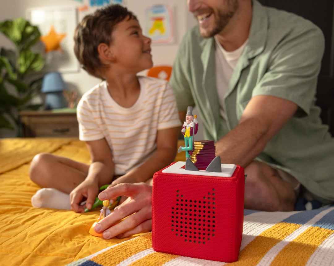 child and adult playing with tonies and a red toniebox