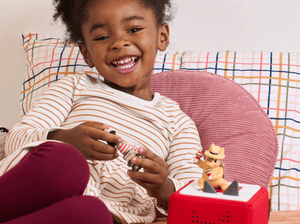 Child playing with Alejandro the Armadillo Tonie audio figurine and Toniebox 2