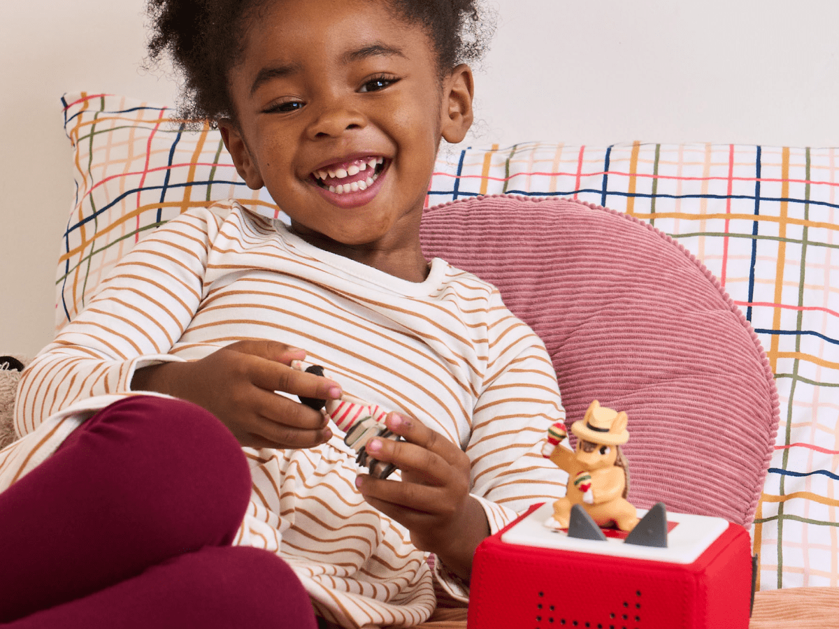 Child playing with Alejandro the Armadillo Tonie audio figurine and Toniebox 2