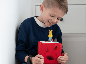 Child playing with Arthur Tonie audio figurine and Toniebox 2