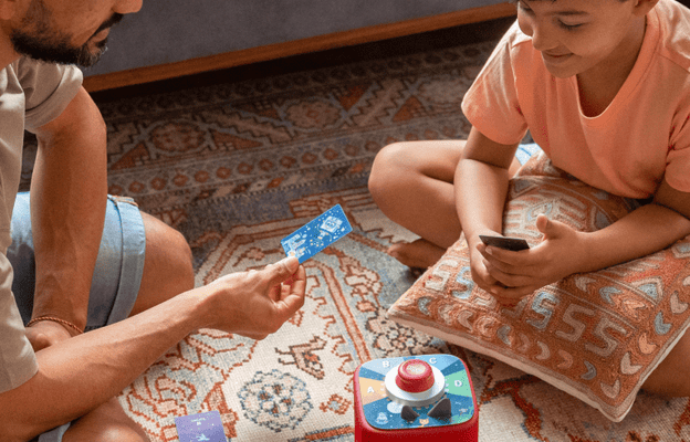 dad and son playing a Tonieplay game together with a red Toniebox 2