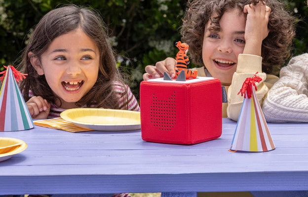 Children having fun at a birthday party with a Toniebox