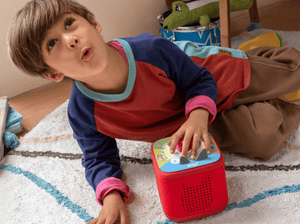 child playing with a red toniebox 2 and Tonieplay Your Playful Day with Bluey