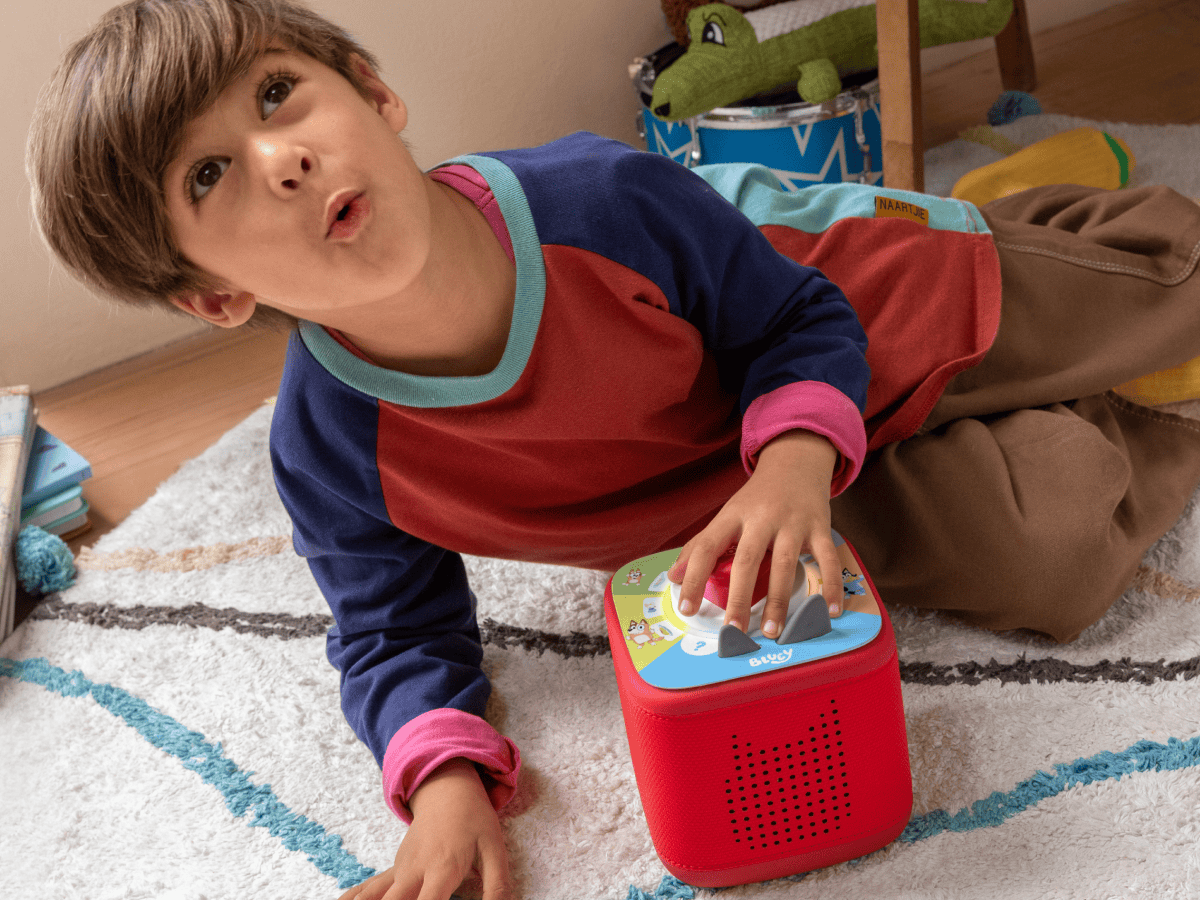 child playing with a red toniebox 2 and Tonieplay Your Playful Day with Bluey
