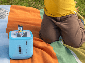 child playing with Toniebox 2, an audio player for kids with Bluey audio figurine