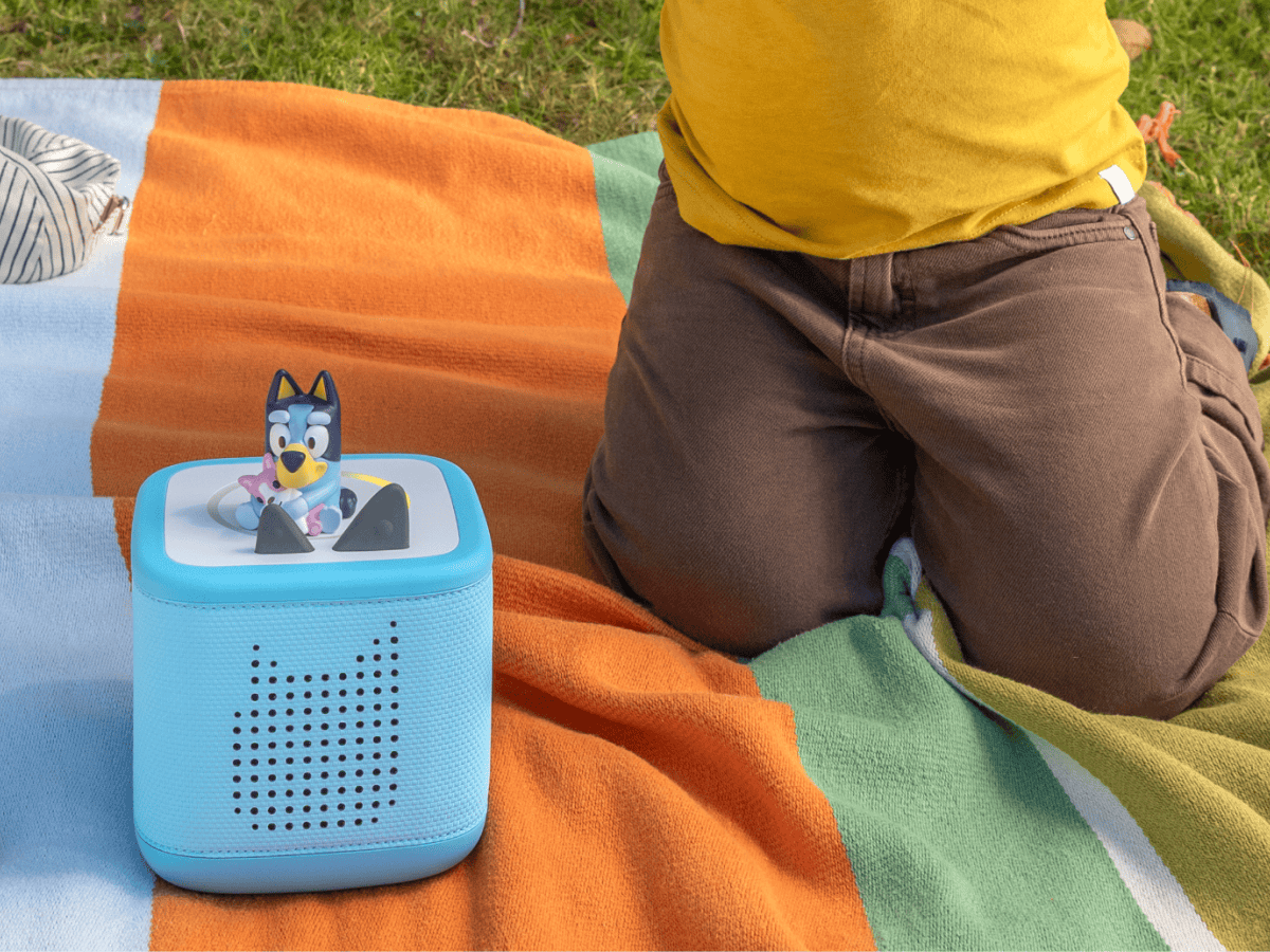child playing with Toniebox 2, an audio player for kids with Bluey audio figurine