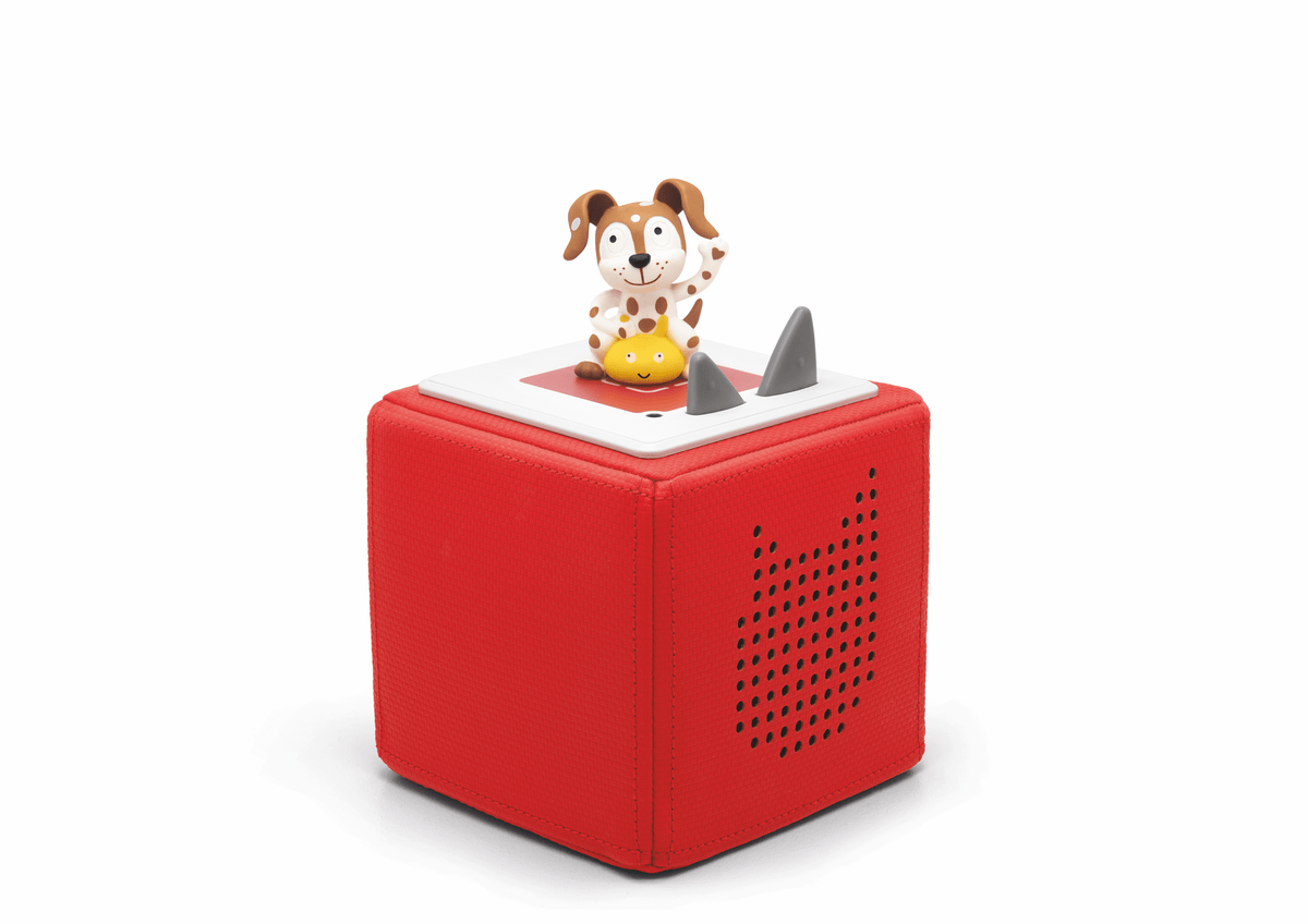 Full view of a Spanish Playtime Puppy Tonie on a red Toniebox
