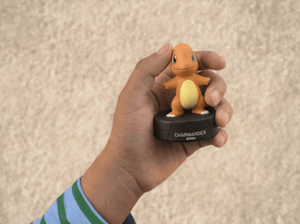 child holding the Pokémon Charmander Tonie