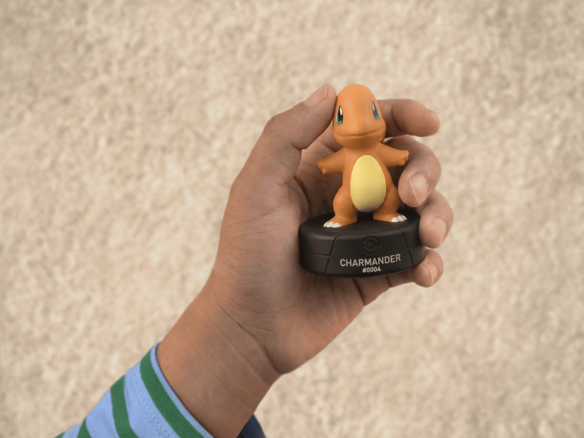 child holding the Pokémon Charmander Tonie