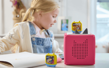 Girl listening to Clever Tonies to spark imagination while learning