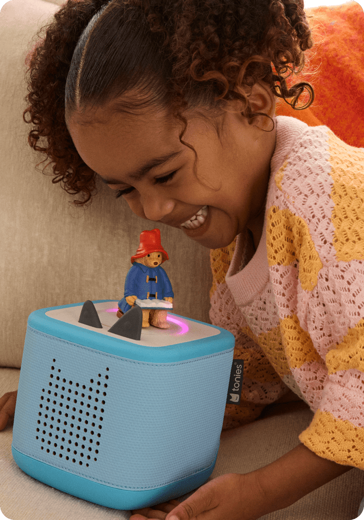 child listening to Paddington Bear Tonie with blue Toniebox 2