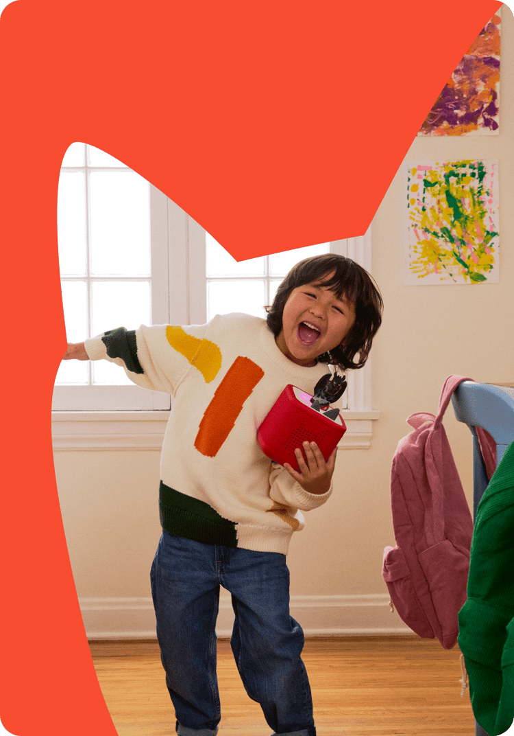 child listening to how to train your dragon tonie on red toniebox 2