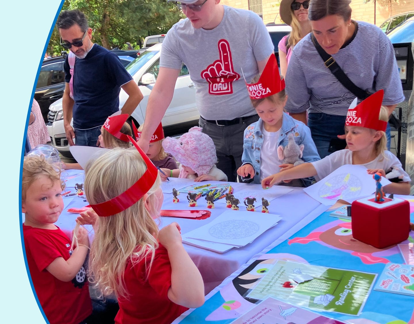 children outside doing crafts together while listening to a Toniebox