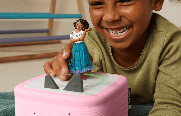 Child listening to Encanto Tonie on a pink Toniebox 2