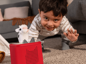 Child playing with My First Tonies Cow audio figurine and Toniebox 2