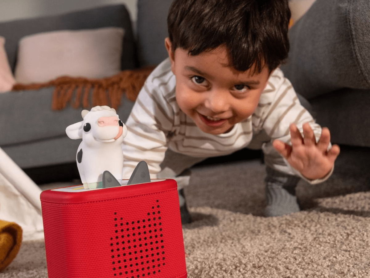 Child playing with My First Tonies Cow audio figurine and Toniebox 2