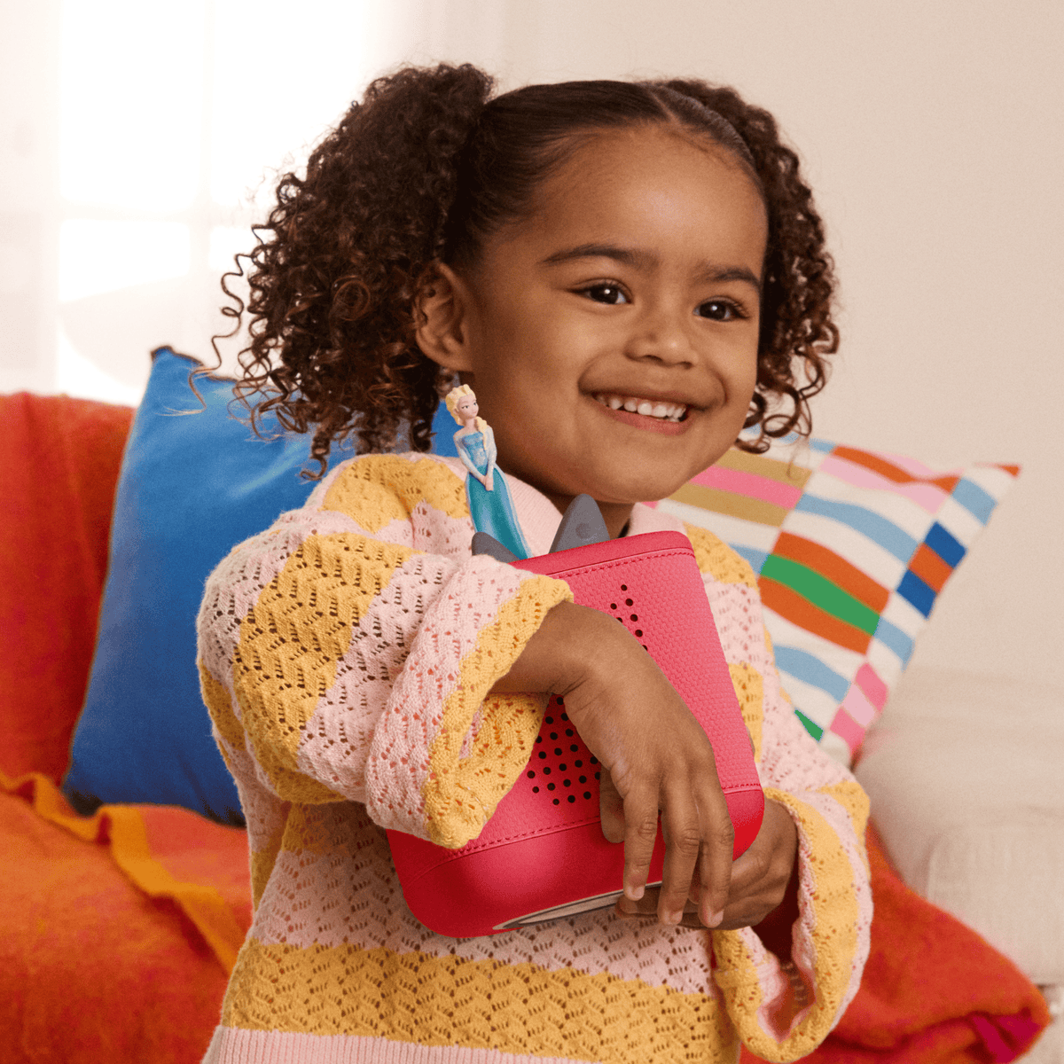 Child playing with Sam's Club Toniebox 2 Disney Bundle - Sunset Red audio figurine and Toniebox 2