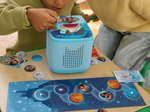 child playing with blue Toniebox 2, tonieplay controller and disney tonieplay game