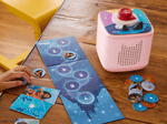 child playing with pink Toniebox 2, tonieplay controller and disney tonieplay game