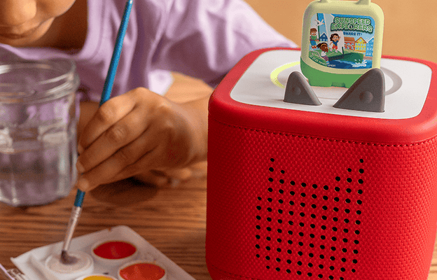 child painting while listening to Sunspeed Explorer Pocket Tonie on a red Toniebox 2