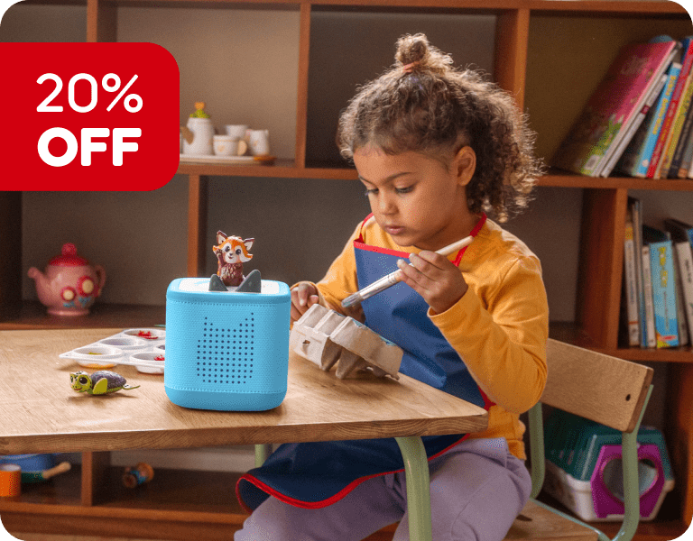 Child painting during craft time while listening to Conservation Crew Tonie on a blue Toniebox 2